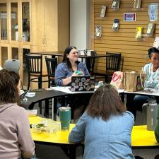 Staff gathered around a table in the library