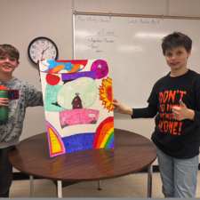 Two students displaying poster