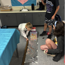 Students work together to measure friction.