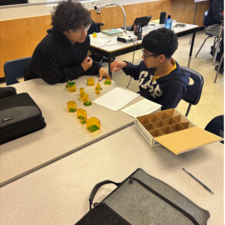 Students learning math by using manipulatives