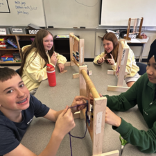 Students working together on a weaving project.