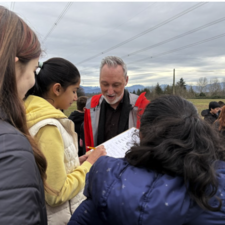 Leyton Schnellert working with students outdoors